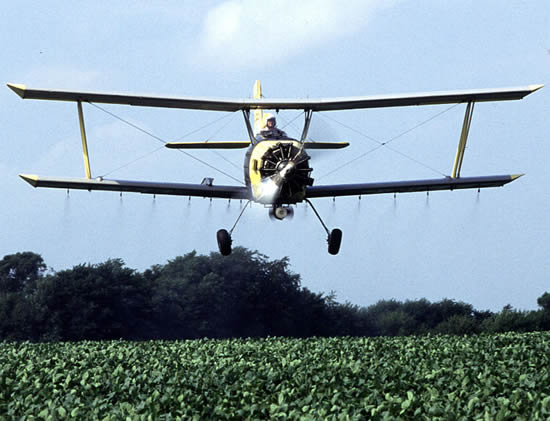 Near Sheldon, Illinois, grower Joe Zumwalt applies a low-insecticide bait that is targeted against western corn rootworms feeding on and laying eggs in these soybeans, Photo by Ken Hammon